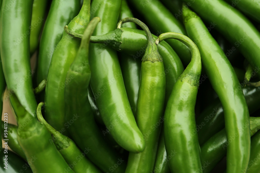 Green hot chili peppers as background, closeup