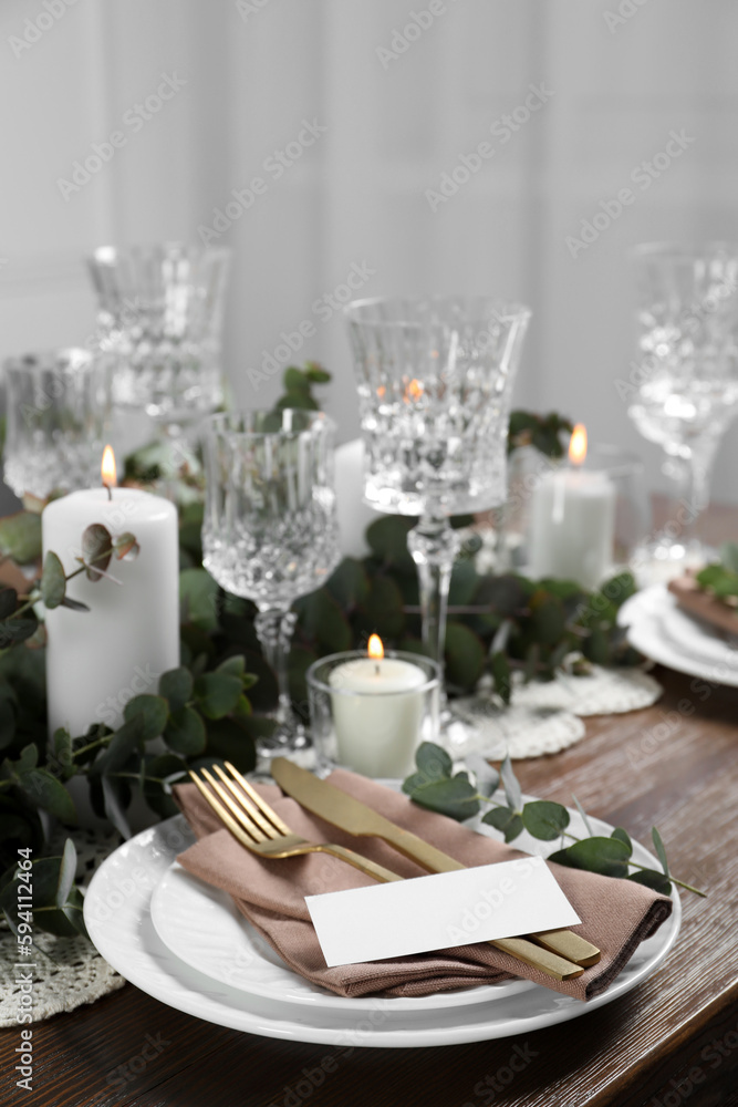 Luxury table setting with beautiful decor and blank card. Festive dinner