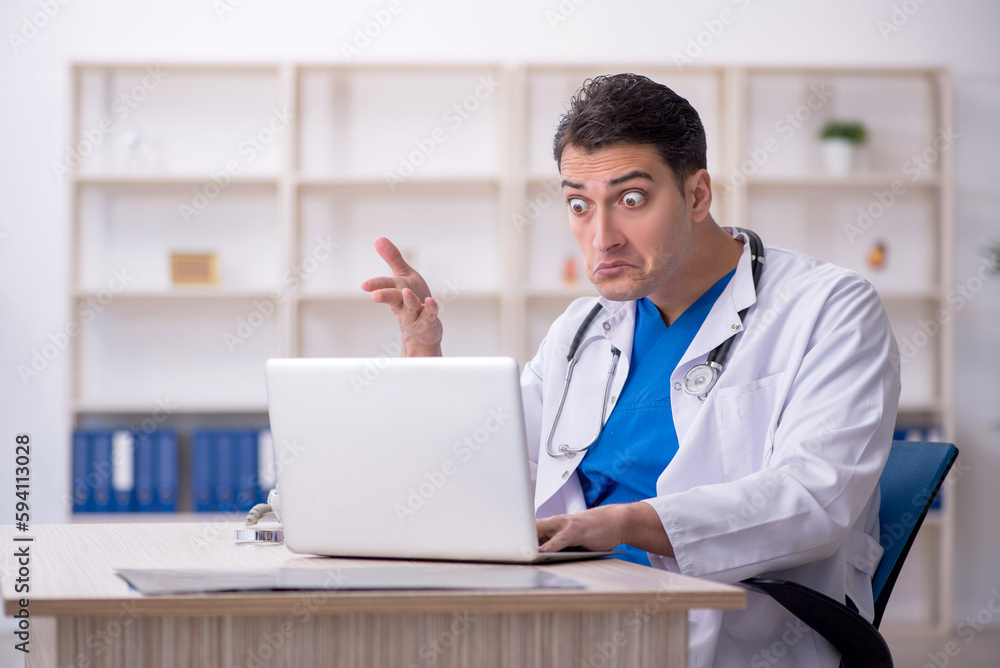 Young male doctor in telemedicine concept Young male doctor in telemedicine concept