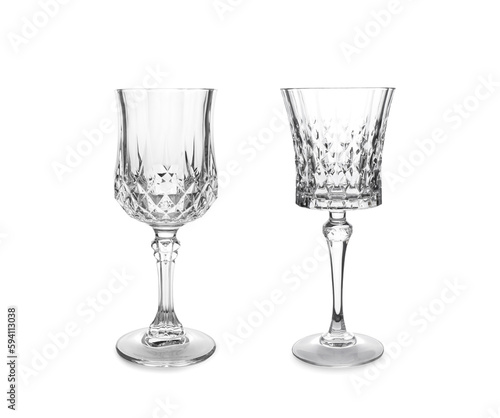 Two beautiful empty glasses on white background