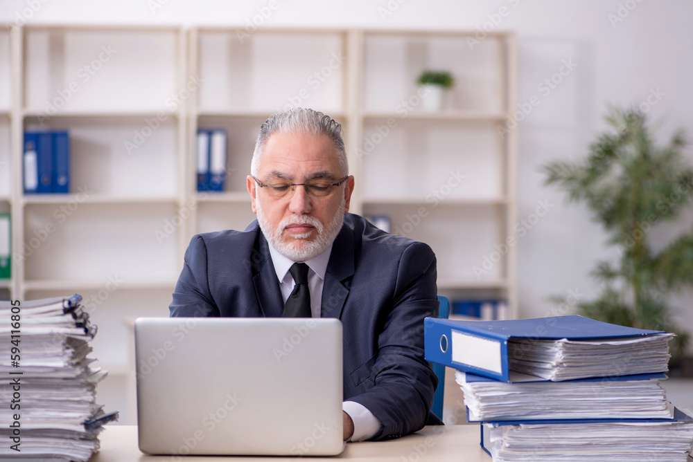 Old male employee and too much work at workplace Old male employee and too much work at workplace