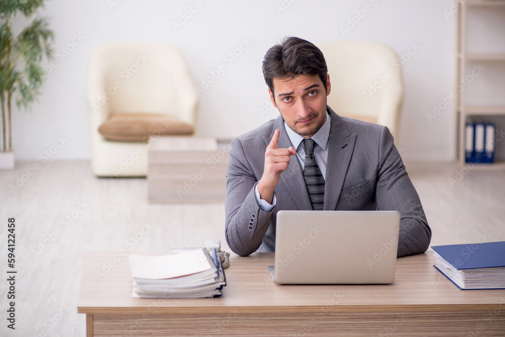 Young male employee working in the office
