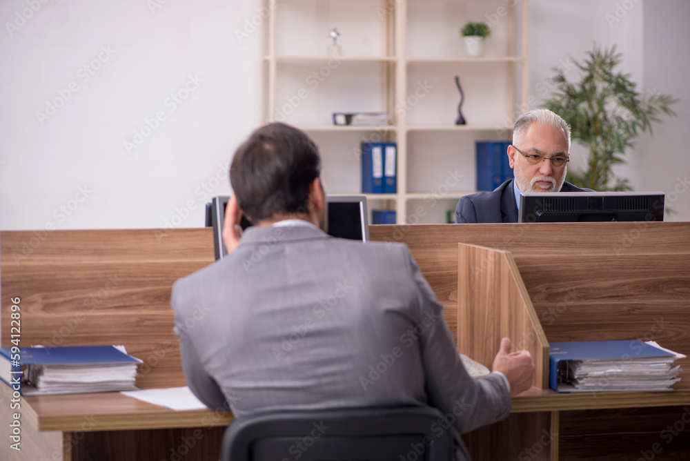 Two male colleagues working in the office Two male colleagues working in the office