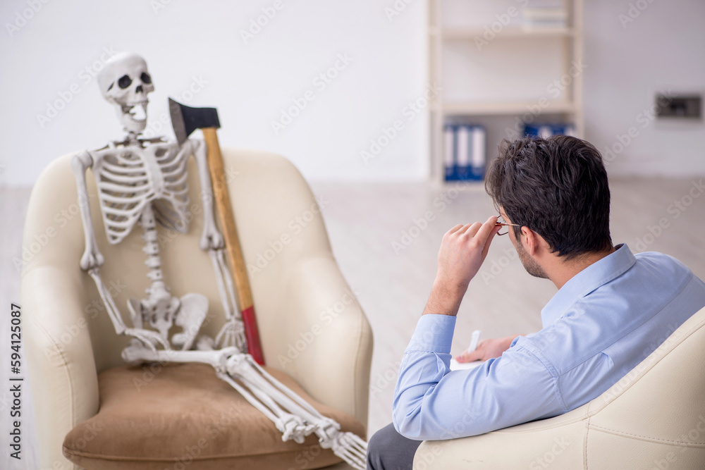 Young male psychologist meeting with skeleton