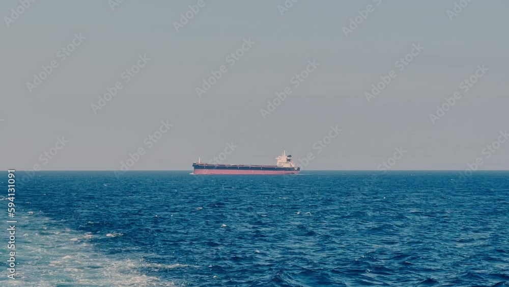 Merchant ship sailing - view from another vessel Merchant ship sailing - view from another vessel