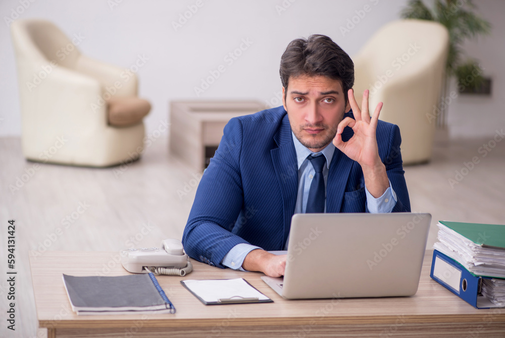 Young male employee working in the office Young male employee working in the office