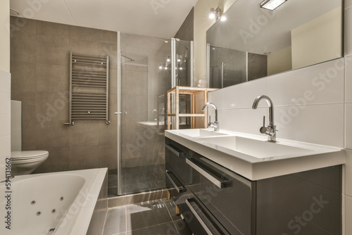 a bathroom with a tub  sink and bathtub in the middle of the room on the right is a large mirror