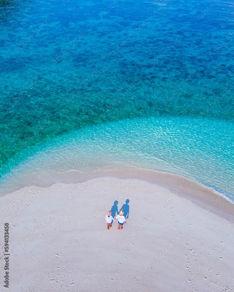 couple of men and women on the beach of Ko Lipe Island Thailand