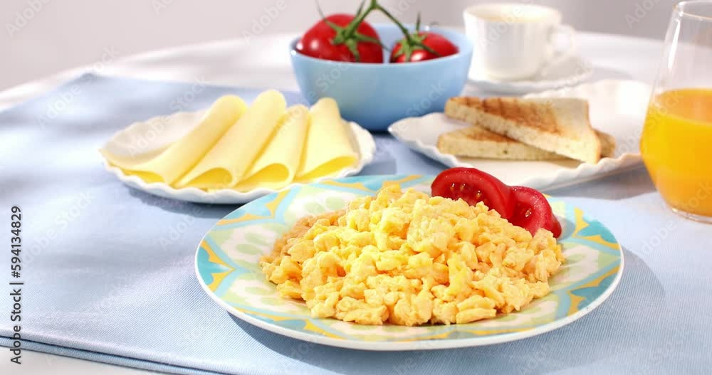 scrambled eggs with bacon and tomato. breakfast on a plate. food on a sunny morning. fried eggs close-up. scrambled eggs with bacon and tomato. breakfast on a plate. food on a sunny morning. fried eggs close-up.