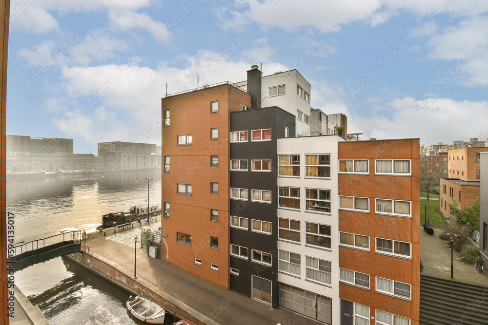 an urban area with buildings and water in the fore, taken from a window looking out to the city below an urban area with buildings and water in the fore, taken from a window looking out to the city below