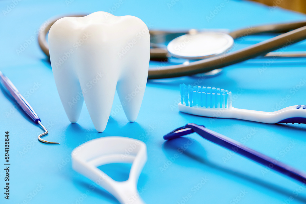 Dental model and dental equipment on blue background, concept image of