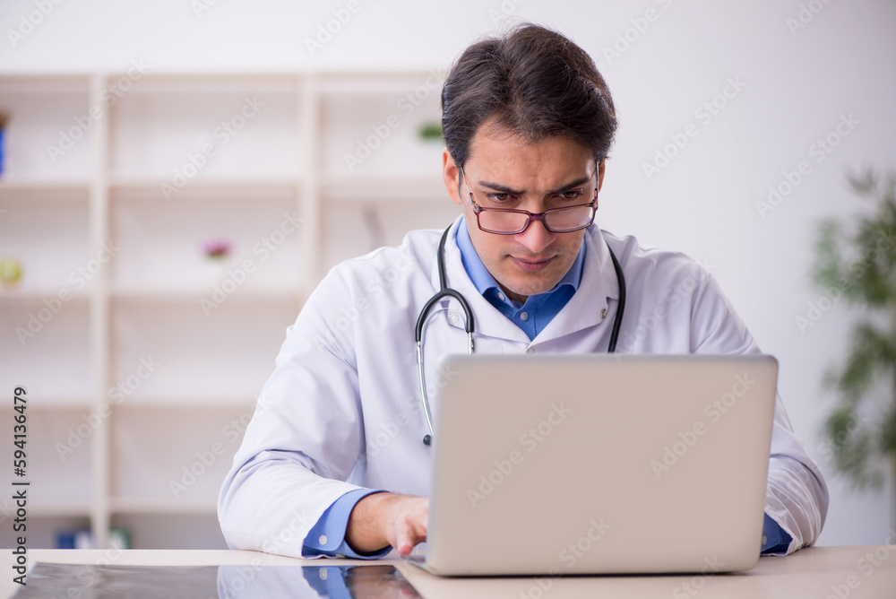 Young male doctor in telemedicine concept Young male doctor in telemedicine concept