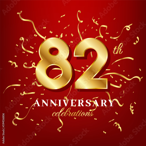 82 golden numbers and anniversary celebrating text with golden confetti spread on a red background © mirvan