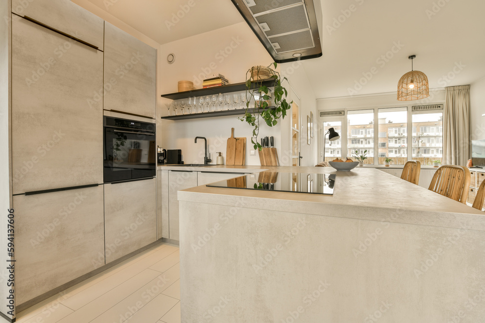 a kitchen and dining area in a house with an open door leading to the living room on the other side a kitchen and dining area in a house with an open door leading to the living room on the other side