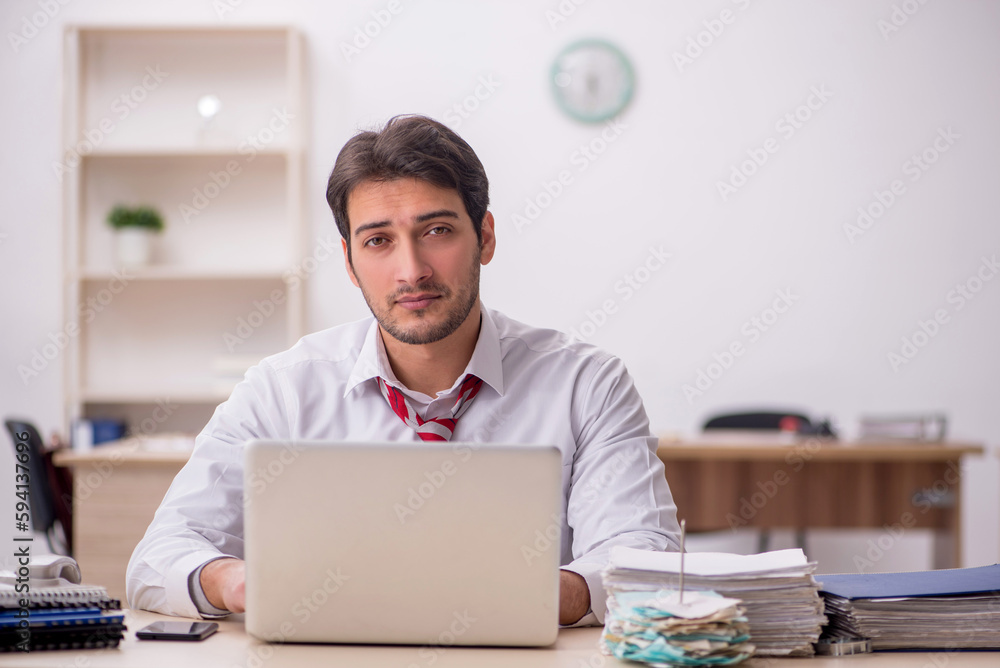 Young male employee working in the office Young male employee working in the office