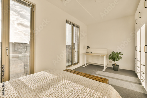 a bedroom with a bed  desk and large window looking out onto the cityscapearrons com
