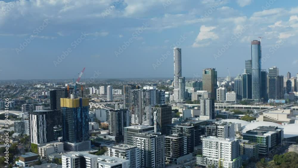 Drone shot flying over West End looking towards Brisbane City. Camera orbiting large apartment block development, with construction crane above on the roof. Drone shot flying over West End looking towards Brisbane City. Camera orbiting large apartment block development, with construction crane above on the roof.