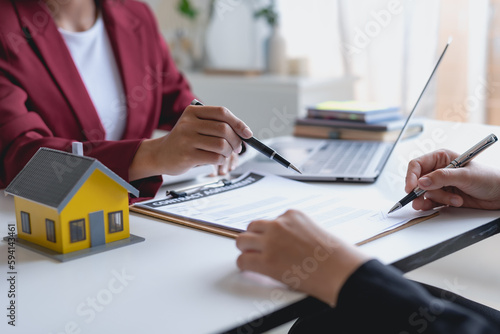 Real estate agent and customer make contract to buy and sell house and land approval of a contract to buy or sell a home offers mortgage loans and home insurance concept.