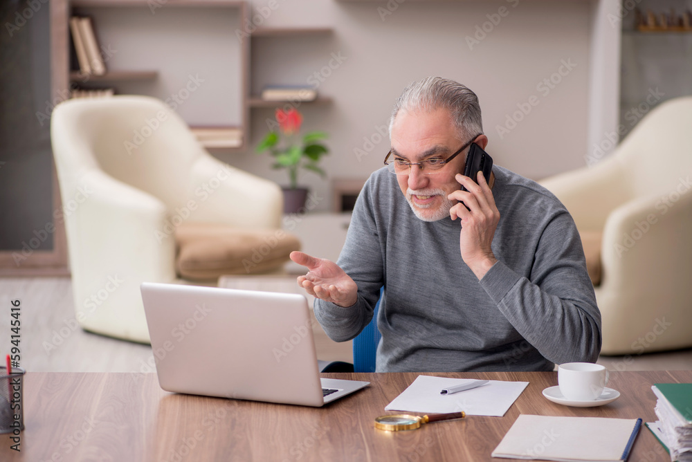 Old male employee working from home during pandemic Old male employee working from home during pandemic