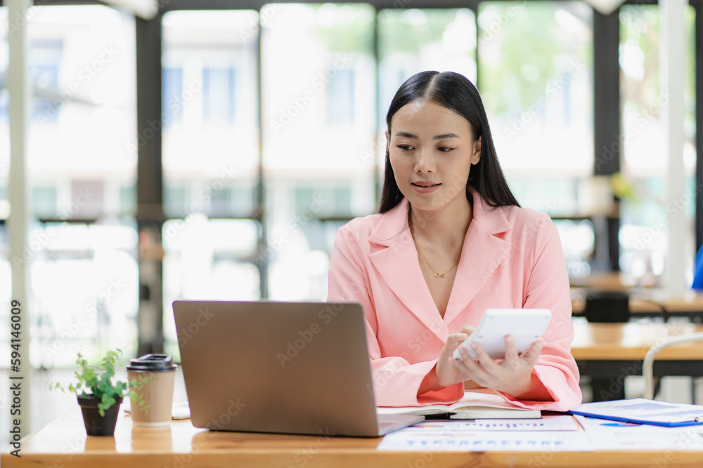Asian female business consultant auditor working at modern office with accounting documents and balance sheet laptop Account verification to prevent bribery in the company Asian female business consultant auditor working at modern office with accounting documents and balance sheet laptop Account verification to prevent bribery in the company