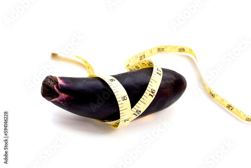 Eggplant with measuring tape on white background.