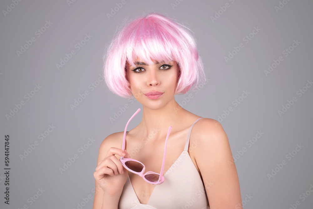 Funny girl with pink wig. Beautiful woman with red lipstick on her lips. Pretty girl natural make up. Beautiful woman face with healthy skin. Sensual female model care skin. Funny girl with pink wig. Beautiful woman with red lipstick on her lips. Pretty girl natural make up. Beautiful woman face with healthy skin. Sensual female model care skin.