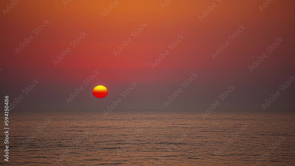 Beautiful orange sunset over an ocean horizon. Time-lapse shot Beautiful orange sunset over an ocean horizon. Time-lapse shot