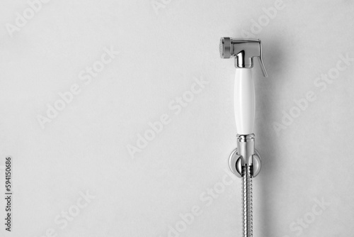 Bidet shower head on wall in toilet