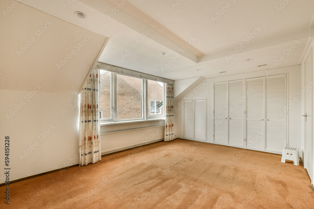 an empty room with white shutters on the walls and doors in the corner to the room is very clean