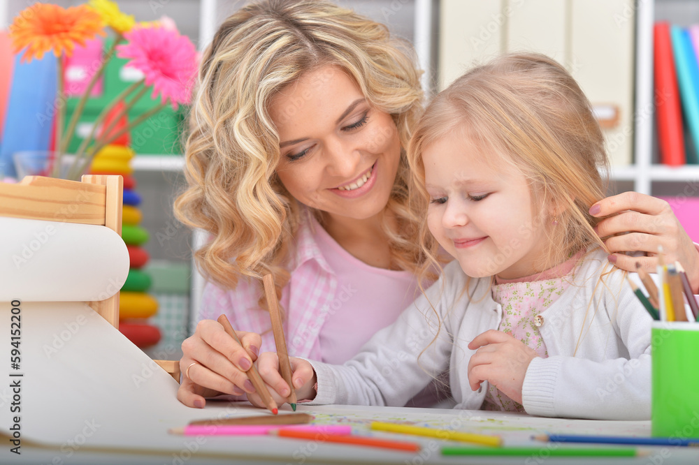 little girl and mother drawing with pencils little girl and mother drawing with pencils