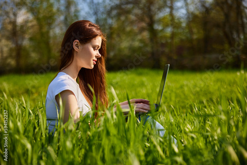 woman with laptop outdoors © VICHIZH