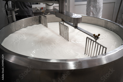 Process of making dairy products in modern dairy factory. Preparing milk for cheese, pasteurization in large tanks. photo