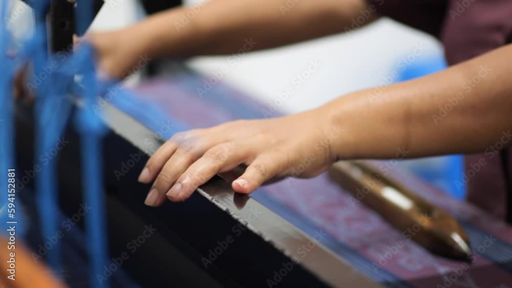Indonesian weaver is weaving activities using ATBM looms (Non-Machine Weaving Tools) in Tarakan, Indonesia. People lifestyle. Indonesian weaver is weaving activities using ATBM looms (Non-Machine Weaving Tools) in Tarakan, Indonesia. People lifestyle.