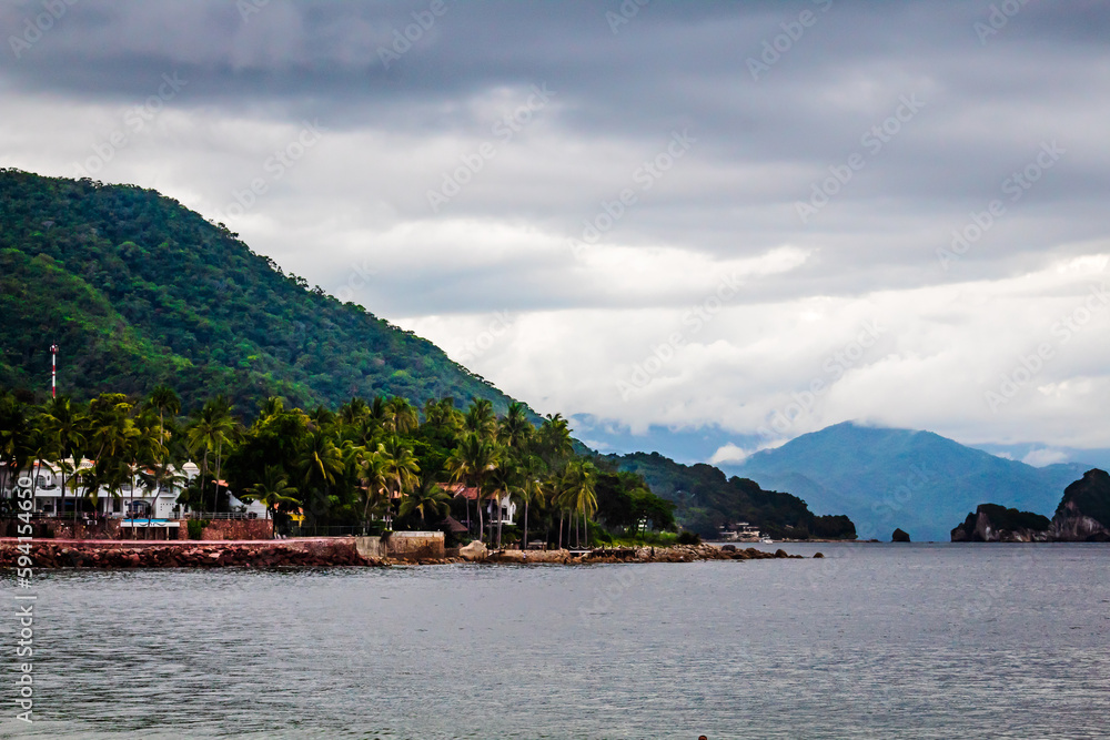 beach at cloudy day  with green mountains and island in the background, puerto vallarta jalisco 