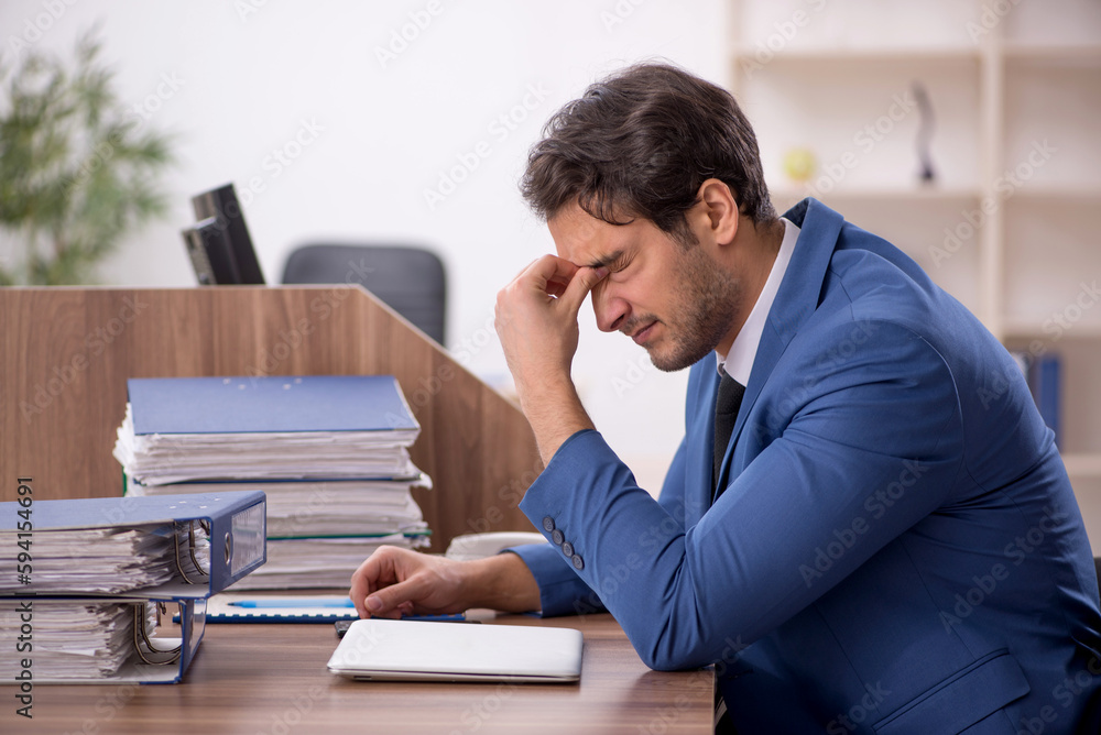 Young male employee working in the office Young male employee working in the office