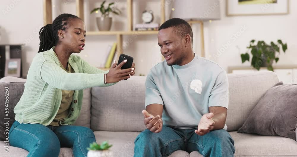 Cheating, phone and couple fighting due to infidelity on social media, online and internet affair in a home lounge. Couch, angry and people in an unhappy relationship or man and woman argument Cheating, phone and couple fighting due to infidelity on social media, online and internet affair in a home lounge. Couch, angry and people in an unhappy relationship or man and woman argument