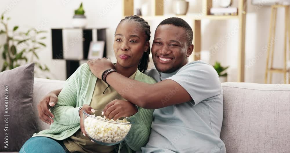Laughing, popcorn and happy couple watching tv on a sofa, hug and bond in their home. Love, snack and black woman with man on couch for date, television or comedy on streaming or subscription service Laughing, popcorn and happy couple watching tv on a sofa, hug and bond in their home. Love, snack and black woman with man on couch for date, television or comedy on streaming or subscription service