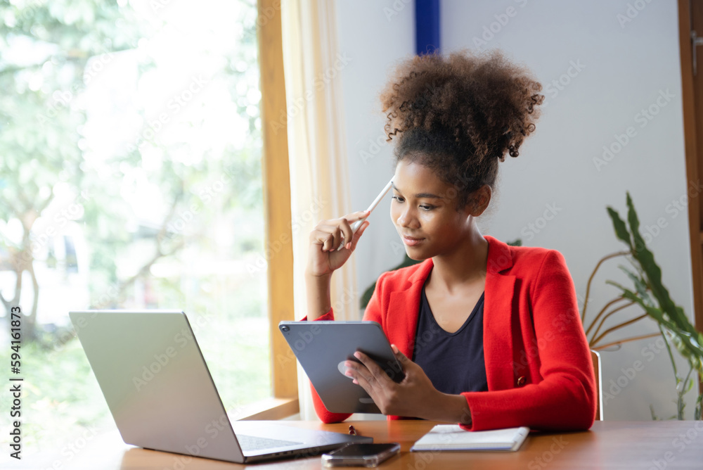 Business woman using tablet and laptop for doing math finance on an office desk, tax, report, accounting, statistics, and analytical research concept Business woman using tablet and laptop for doing math finance on an office desk, tax, report, accounting, statistics, and analytical research concept