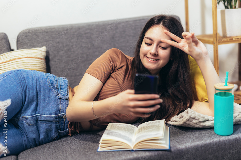 Happy teen girl using smartphone app enjoying online virtual chat video call with friends Happy teen girl using smartphone app enjoying online virtual chat video call with friends