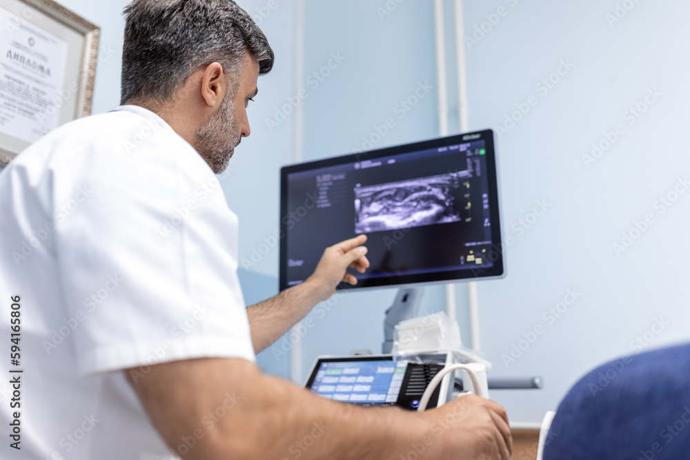 At the medical clinic, Caucasian male doctor doing the doppler ultrasound test evaluation of arteries and veins on a female patient