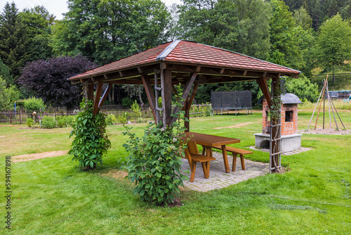 wooden gazebo and table on grass