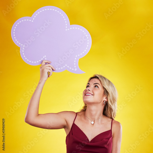Smile, looking and woman with speech bubble in studio isolated on a yellow background. Poster, word cloud and happy female person holding advertising banner for marketing, opinion or social media.