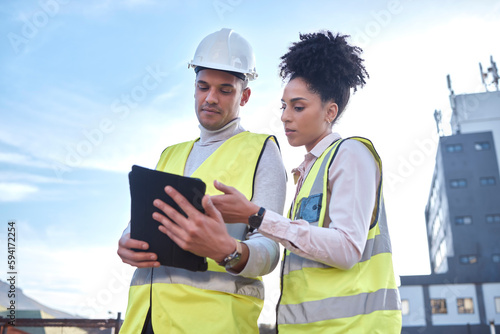 Architect, tablet and construction in planning, idea or collaboration for project plan in the city on site. Man and woman contractor working together on technology for architecture ideas or building