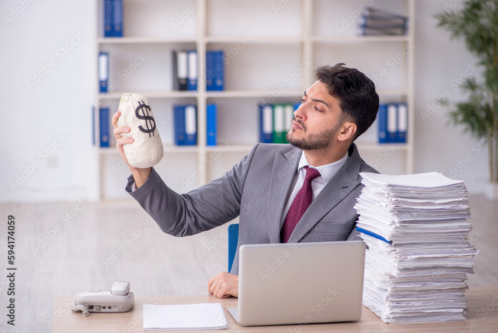 Young male employee in remuneration concept Young male employee in remuneration concept
