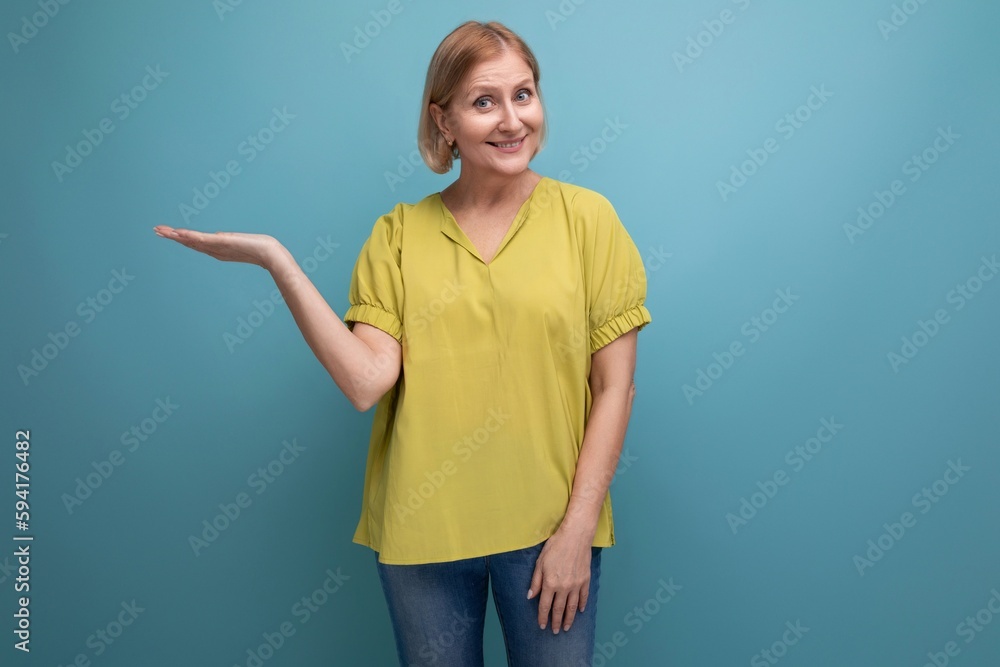 attractive 50s blonde woman in yellow t-shirt posing attractive 50s blonde woman in yellow t-shirt posing