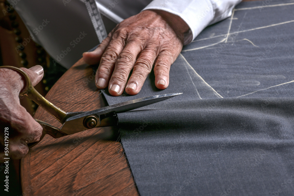 A tailor cutting a cloth according to the tradition of tailors. The