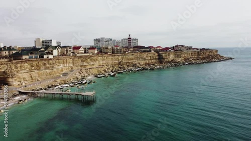 Video from a drone of a rock trail in the city of Aktau. A bird's-eye view of the coastal cliffs on a summer evening. Slow camera movement along the coastal zone