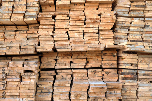 A large warehouse of wooden boards of various sizes for construction.