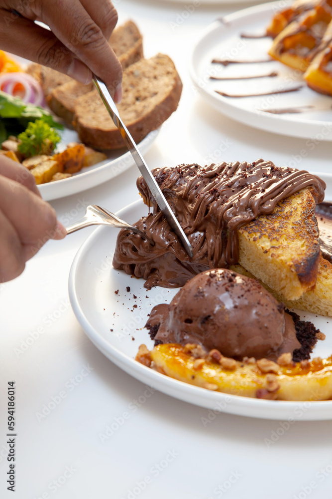 Chocolate french toast and banana slice served with chocolate gelato. Chocolate french toast and banana slice served with chocolate gelato.