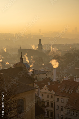 morning shot of the roofs of the old town of the waking city with smoke rising from the chimneys, Prague the capital of the Czech Republic